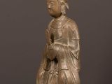 a bronze statue of a woman with a crown on her head