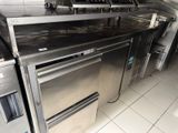 stainless steel counter top in a commercial kitchen with ovens and stoves