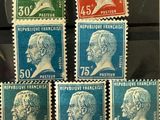 six different colored stamps of different sizes and shapes on a piece of paper
