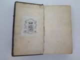 an open book with a drawing of a coat of arms on it
