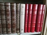 many books on a shelf in a library