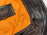 a close up of a leather jacket with a tag on it