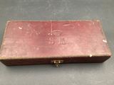 an old wooden box with a number on it sitting on top of a table
