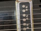 a close up of an electric guitar with a case on it
