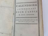an old book with writing on it sitting on top of a table