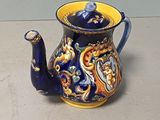 a blue and yellow teapot sitting on a table