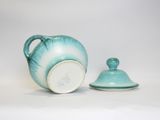 a tea pot and a teapot sitting next to each other