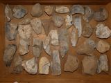 a wooden box filled with various pieces of stone