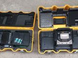 two yellow and black cases with electronic equipment in them sitting on the ground