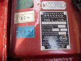 a close up of a red machine with a lot of stickers on it