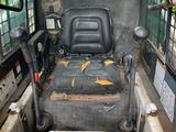 a seat on the back of a tractor that is sitting in the back of a truck
