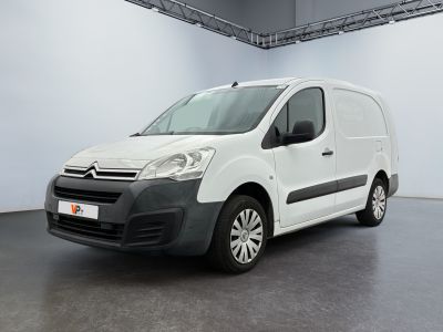 the white van is parked in the large room of the building