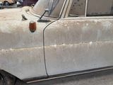 an old car that is parked in a lot