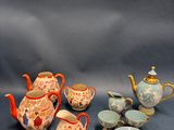 many different types of teapots and plates on the table