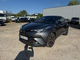 a grey toyota c - hr is parked in a parking lot