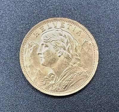 a gold coin with a woman ' s face on it