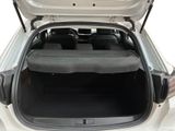 the back of a white car with its trunk open showing the seats