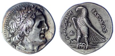 a close up of a coin with a bird on it
