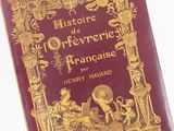 the front cover of a red book with gold writing on it