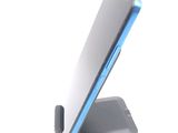 a phone that is sitting on a stand on a white surface