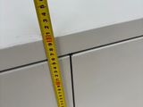 a measuring tape that is on top of a filing cabinet