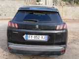 a black car parked in front of a building