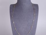 a gold chain necklace on a mannequin mannequin display
