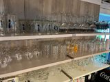 many glasses and bottles on the shelves in the store