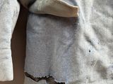 a close up of a jacket on a hanger on a wall