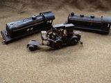 three toy trains sitting next to each other on the ground
