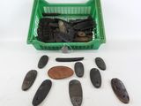 several pieces of wood are in a green basket next to a penny