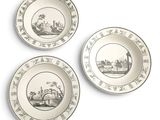 three plates with black and white designs on them on a white surface