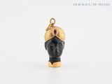 a close up of a black head with a gold crown on it