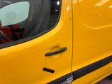 a close up of a yellow van door with a sticker on it