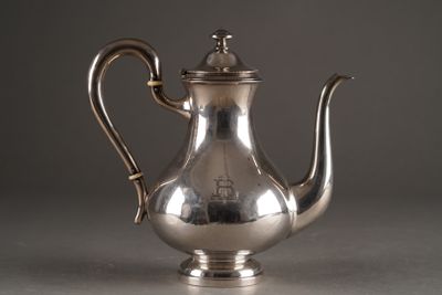 an antique silver tea pot with a handle on a table