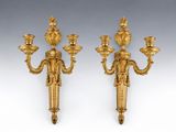 a pair of gilded bronze wall sconces on a white background