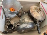 many pots and pans in a box on the floor