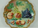 une assiette sur laquelle est représenté un tableau représentant des fruits, posée sur une table