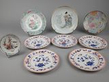 several plates with asian designs are arranged on a gray surface