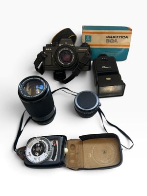 a lot of different types of cameras on the table