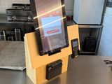 a tablet that is sitting on a table in a kitchen