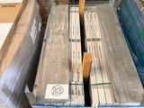 boxes of wood sit on a pallet in a warehouse