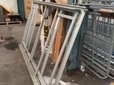 a large pile of metal frames in a warehouse