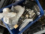 a blue container filled with assorted items sitting on a table