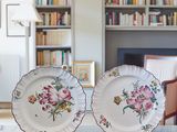 two plates that are sitting on a table in front of a bookshelf