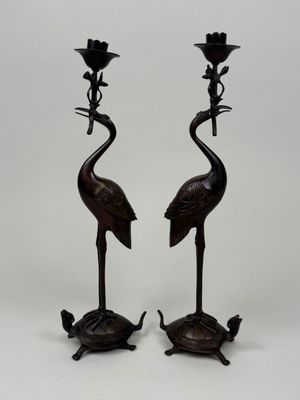 pair of bronze candlesticks with birds and flowers on them