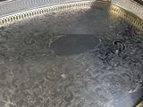 a large silver tray with a decorative design on it