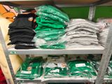 many bags of clothing on the shelves in the store