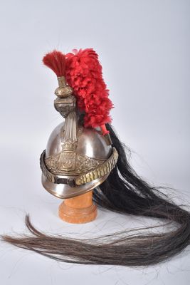 a helmet with a red feather on top of it