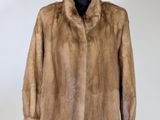a close up of a fur coat on a mannequin stand